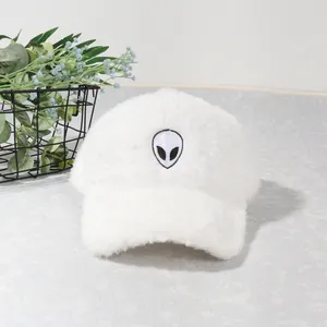 Detailed view of the fuzzy white baseball cap with an alien embroidered patch