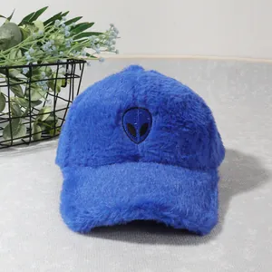 Detailed view of plush royal blue baseball cap with black alien head embroidery
