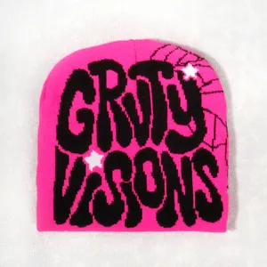Detail of rose pink knit beanie with black jacquard text and spider web graphic pattern