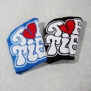 Close-up of thick knitted beanie featuring heart and letter patterns in Y2K street style