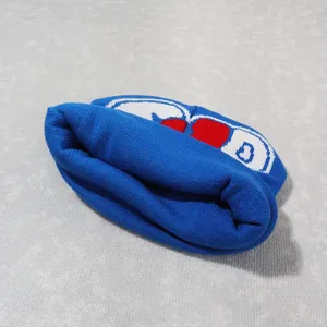 Detail of royal blue Y2K knitted beanie featuring red and white jacquard pattern and D letter