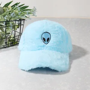 Detail of light blue fuzzy baseball cap with alien embroidery and soft plush texture