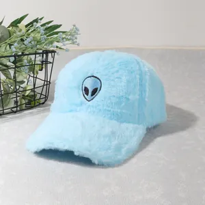 Detail of plush sky blue baseball cap featuring a black alien embroidery and soft texture