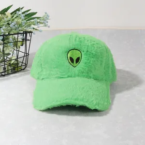 Close-up of bright green plush baseball cap with alien embroidery and thick faux fur texture