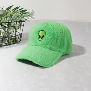 Detail of bright green plush baseball cap featuring a cute embroidered alien patch