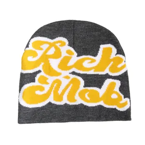 Dark grey knitted beanie featuring bold yellow Rich Mob letter jacquard pattern