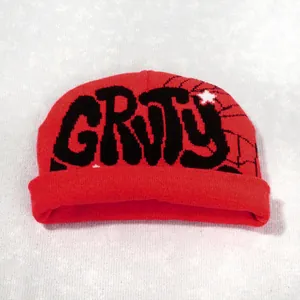 Close-up of red cuff beanie featuring GRVY embroidery with star and spider web details