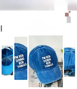 Close-up of vintage blue washed denim baseball cap with I'M BOB embroidery and adjustable buckle