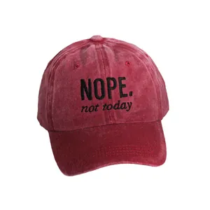 Japanese style washed red baseball cap with NOPE embroidery and a curved brim