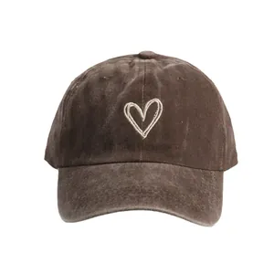 Brown washed cotton baseball cap with white heart embroidery and curved brim