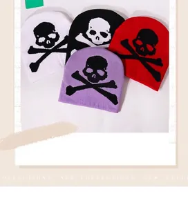 Detailed view of four colorful Y2K gothic skull jacquard knit beanies with thick texture
