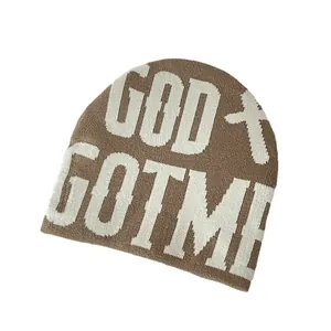 Brown knit beanie featuring GOD GOT ME white jacquard lettering and cross pattern