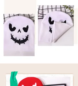 Close-up of Halloween knit hats featuring jacquard ghost patterns in white and red colors