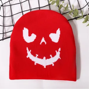 Red knit beanie featuring a white pixelated monster face for Halloween party warmth