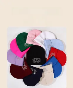 Detailed collection of knit beanies with sparkly rhinestone butterfly in multiple colors