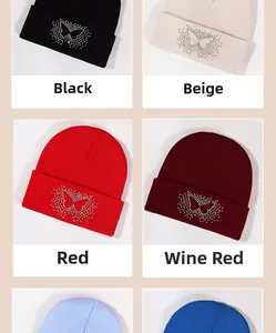 Detail view of rhinestone butterfly patterns on knitted beanies in four distinct colors