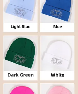 Detail view of rhinestone butterfly pattern on ribbed knit beanies in various colors