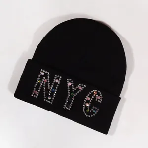 Black knitted beanie hat featuring colorful NYC rhinestone embellishments on the brim