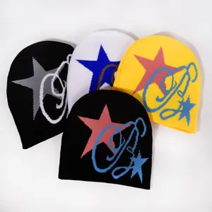 Flat lay of star pattern knitted beanies in black, white and yellow color options