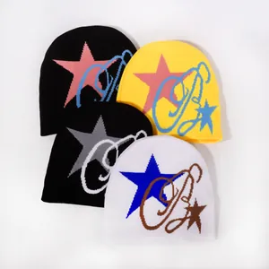 Flat lay view showing knitted beanies with star patterns in black, yellow and white colors