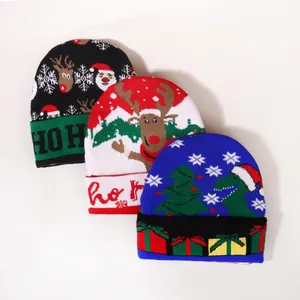 Three Christmas knitted beanies with Santa, reindeer and dinosaur patterns on white background