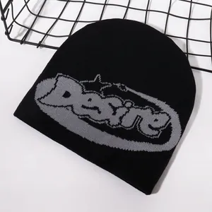 Black knit beanie hat featuring gray Desire jacquard lettering in a street fashion style