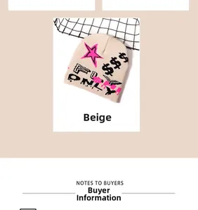 Close-up of beige knit beanie featuring pink star and pixelated graphic details