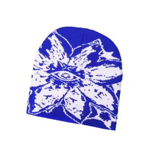 Blue and white jacquard knit beanie featuring abstract floral eye patterns for winter