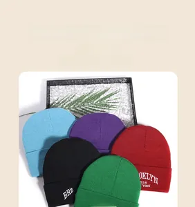 Detail of colorful knit beanies with Brooklyn 1898 embroidery and thick cuffed texture