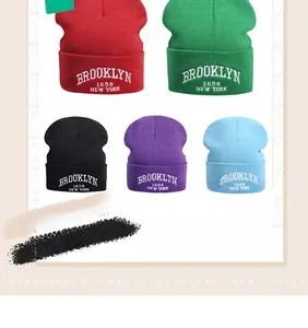 Detail showing various colors of knit beanies with Brooklyn 1898 embroidery text