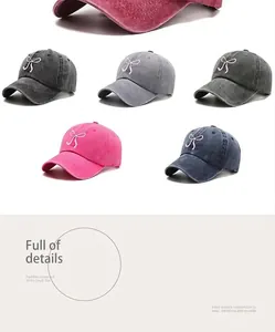 Detail of washed cotton baseball caps with pink bow embroidery in various colors
