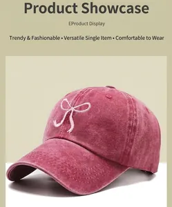 Detailed close-up of white bow embroidery on washed denim pink baseball cap texture
