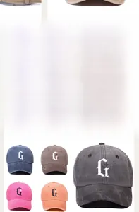 Detail of washed cotton baseball caps with embroidered G logo in five vintage colors