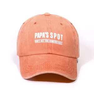 Washed cotton baseball cap in brick orange with Papa's Spot letter print on white background