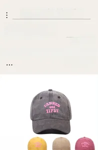 Detail of five washed cotton baseball caps with pink TANNED embroidery in various colors