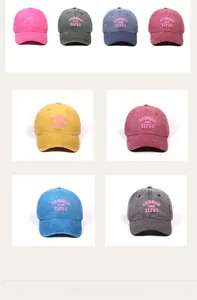 Detail of multi-color washed cotton baseball caps with TANNED and TIPSY pink embroidery