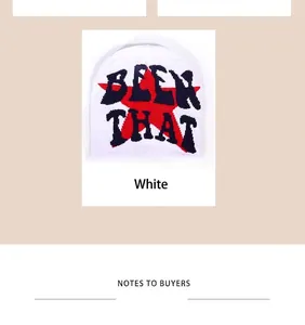 Detail of white beanie featuring red star embroidery and blue Been That lettering
