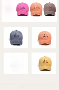 Detail view of washed cotton baseball caps in blue, pink, orange, gray and yellow colors