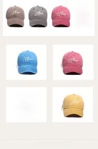 Detailed close-up showing embroidered text and heart pattern on washed cotton baseball caps