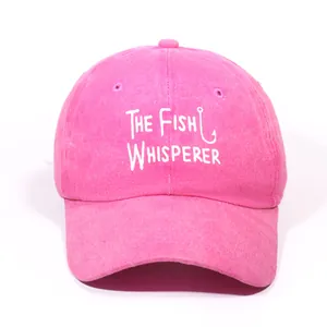 Pink cotton baseball cap featuring white The Fish Whisperer embroidery on a plain background