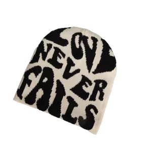 Knitted beanie with Love Never Fails jacquard pattern in black and white street style