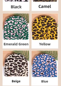 Detail view of leopard print knit beanies in black, camel, emerald, and beige colors