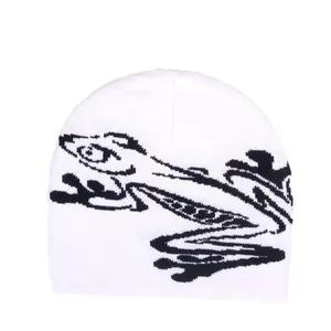 White knitted beanie with black frog pattern in a trendy American street style