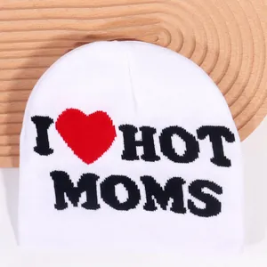 White knit beanie featuring bold black I Heart Hot Moms lettering on rustic wood texture