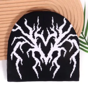 Y2K style beanie with white spider web jacquard on black knit for winter warmth