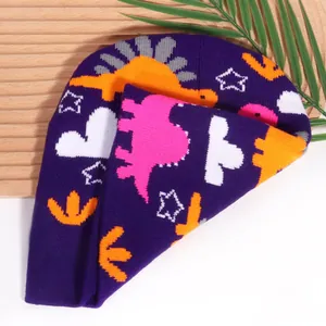 Purple knitted baby beanie featuring colorful dinosaur jacquard patterns for warm outdoor wear