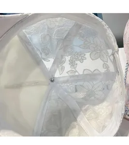 Detailed interior of a white lace baseball cap featuring mesh lining and reinforced stitching