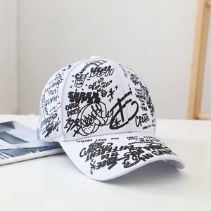 Detail shot of the cotton twill texture and black graffiti print on a white baseball cap