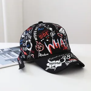 Detail of black graffiti baseball cap showing colorful street art prints and long strap