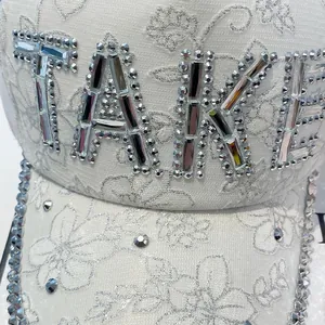 Sparkly white baseball cap with rhinestone TAKE letters and glitter floral patterns